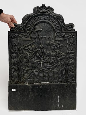 Lot 689 - A cast iron fire back cast with a figure and a...