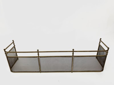 Lot 712 - A Victorian brass fender with tubular top rail,...