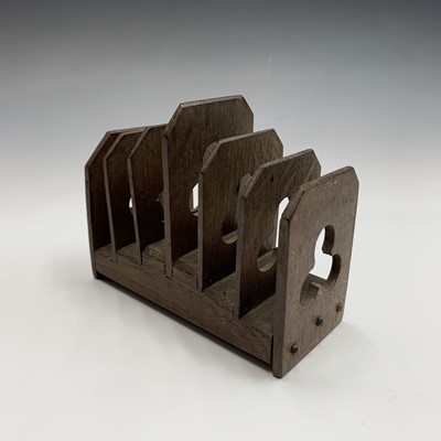 Lot 90 - An arts and crafts oak letter or toast rack,...
