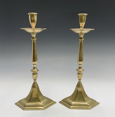 Lot 121 - A pair of tall continental brass candlesticks,...