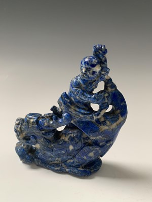 Lot 110 - A Chinese lapis lazuli carving of a boy on a...