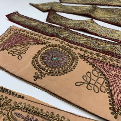 Lot 399 - Nine Indian metal thread embroidered panels,...