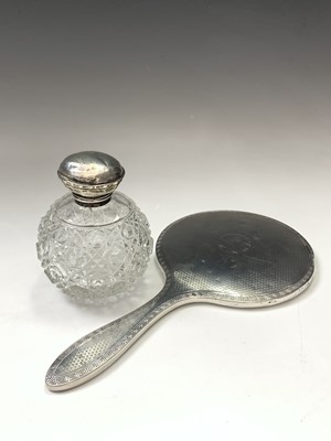 Lot 48 - An engine-turned silver-mounted hand mirror, a...