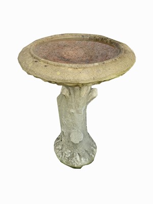 Lot 2030 - A reconstituted stone bird bath on cast tree...