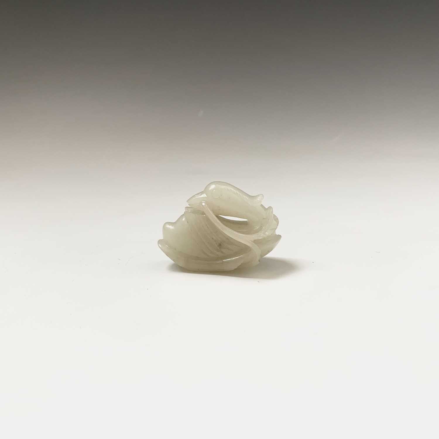Lot 16 - A small Chinese white jade carving of a duck,...