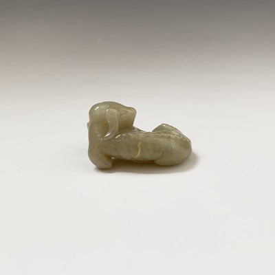 Lot 20 - A Chinese jade carving of a recumbent hound,...