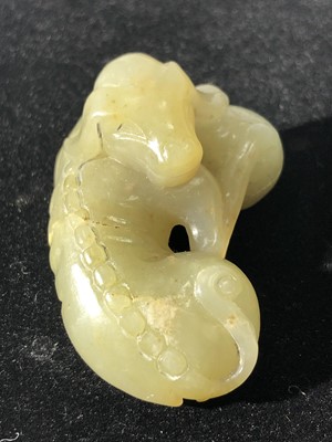 Lot 20 - A Chinese jade carving of a recumbent hound,...
