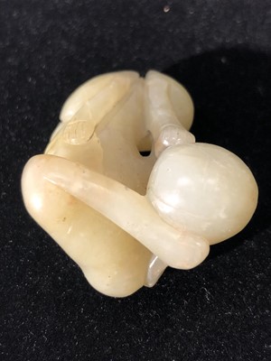 Lot 23 - A Chinese jade carving of a recumbent hound,...