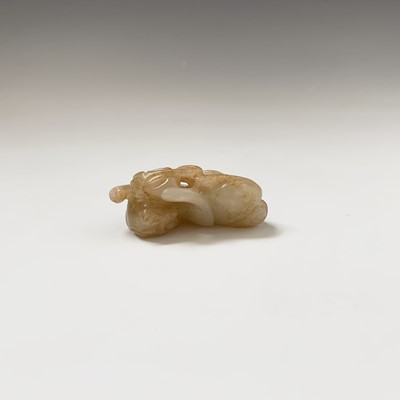 Lot 21 - A Chinese carved jade figure of a feline, with...