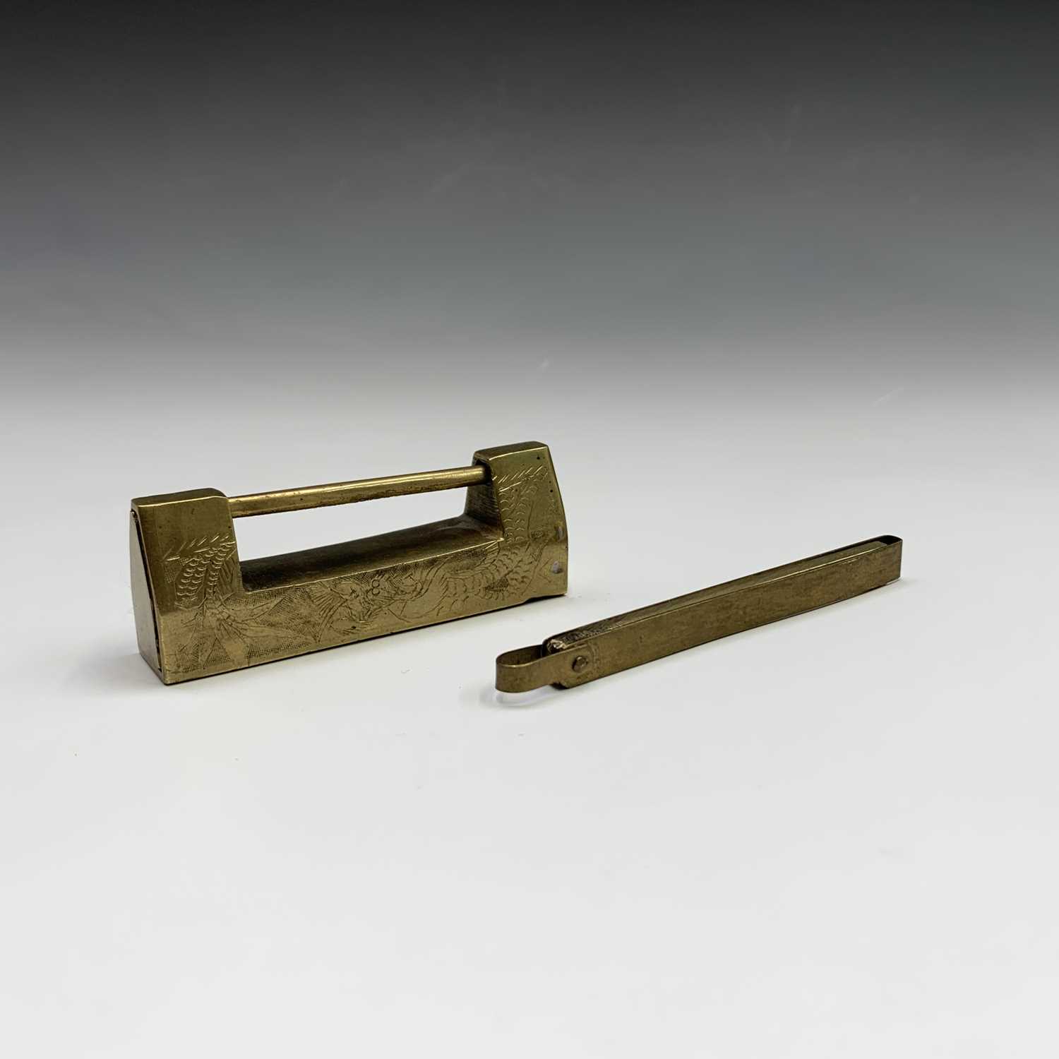 Lot 307 - A Chinese brass padlock with key, engraved...