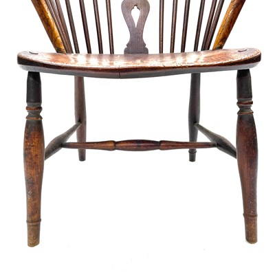 Lot 96 - An ash and elm wheelback windsor armchair, 19th century.