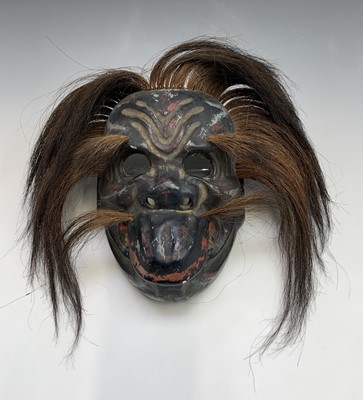 Lot 88 - A Japanese carved wooden painted mask, Meiji...
