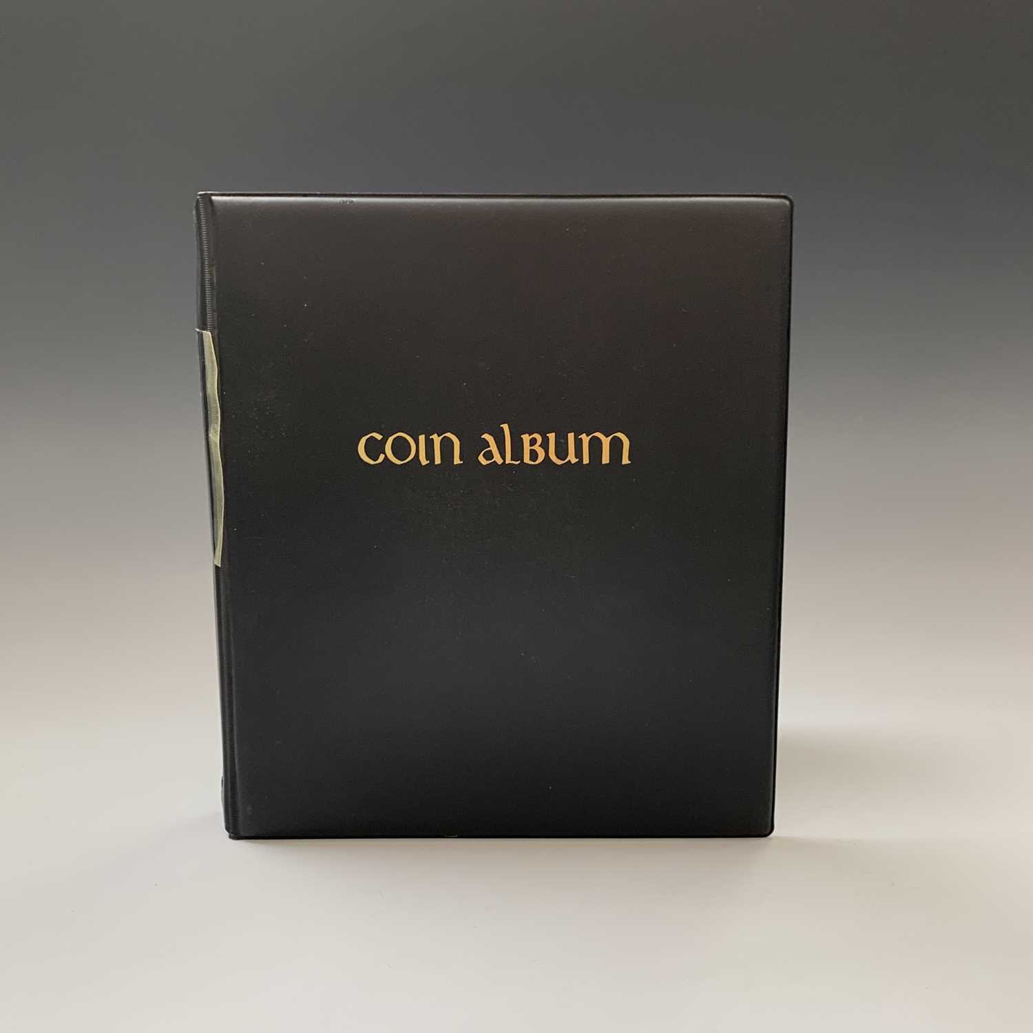 Lot 55 - WORLD COINS: An album containing a quantity of...
