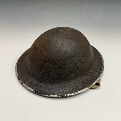 Lot 241 - A Second World War policeman's helmet.