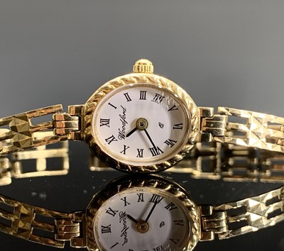 Lot 517 - A ladies gold watch with gold bracelet by...