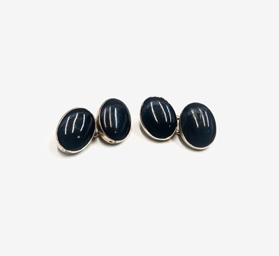 Lot 659 - A pair of gold and black onyx cuff links