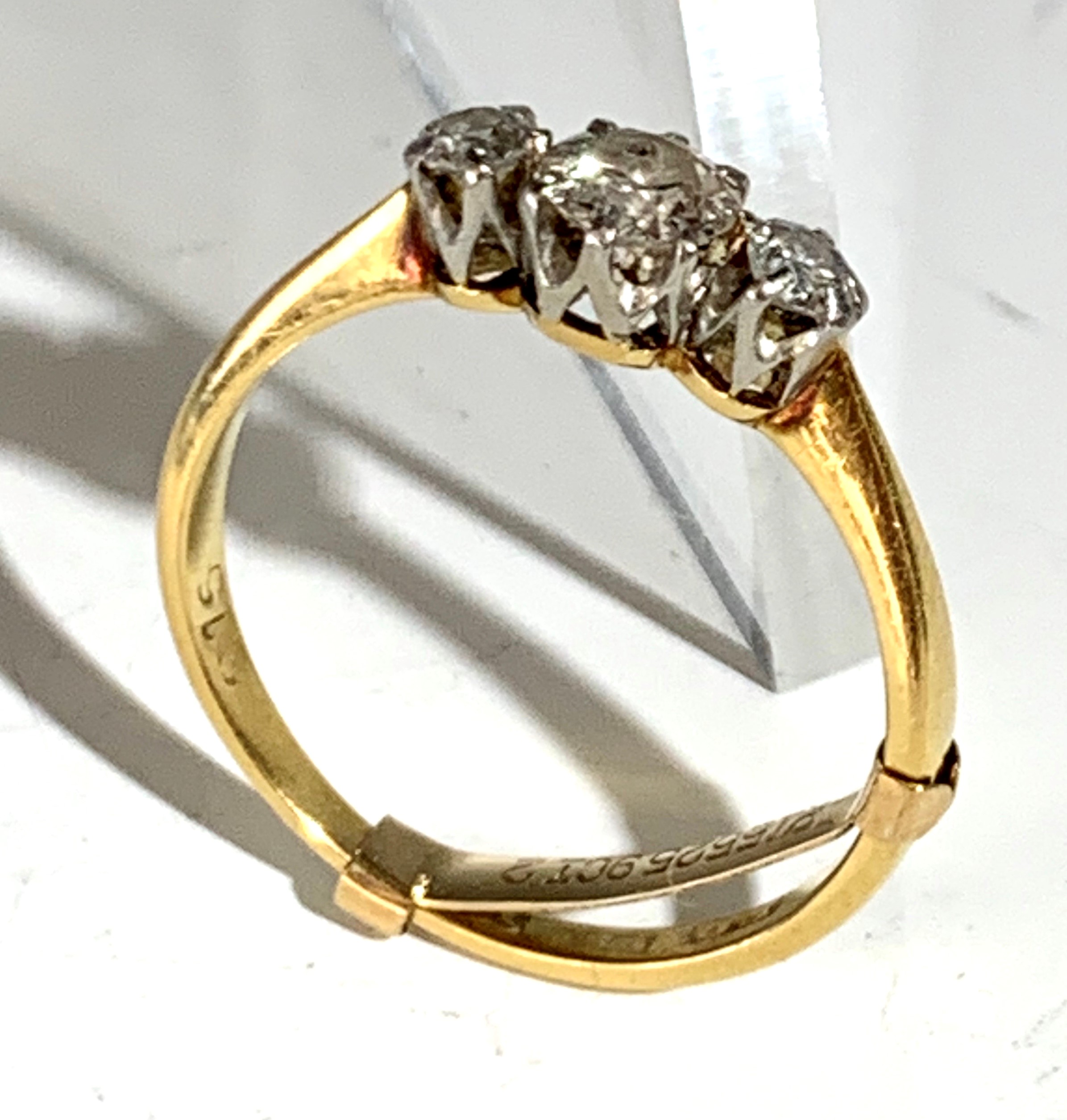 Lot 2444 - An 18ct gold ring set three diamonds.