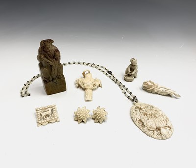 Lot 661 - A carved ivory pendant, a netsuke other...