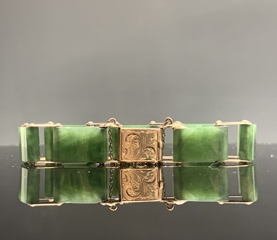 Lot 576 - A 9ct gold and jade link bracelet with chased...