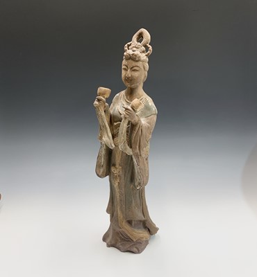 Lot 222 - A Chinese earthenware figure of Guanyin, with...