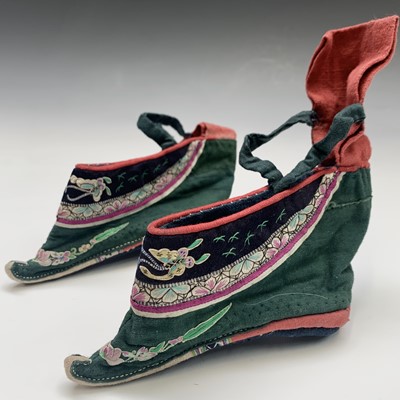 Lot 99 - A pair of Chinese silk embroidered lotus shoes,...