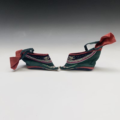Lot 99 - A pair of Chinese silk embroidered lotus shoes,...