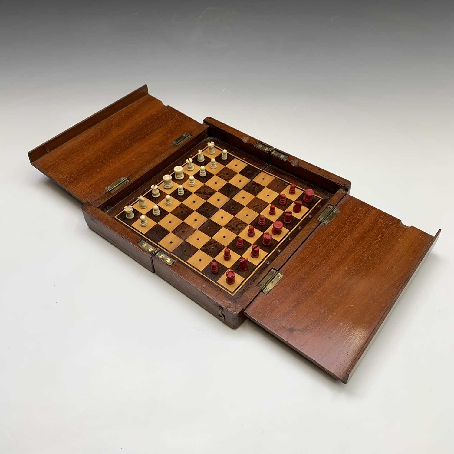 Lot 337 - A mahogany folding travel chess set, circa...