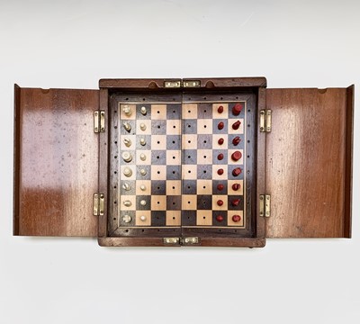 Lot 337 - A mahogany folding travel chess set, circa...