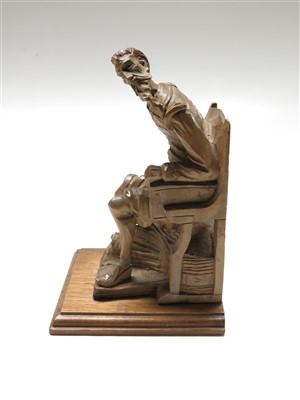 Lot 189 - A Black Forest carved wood figure of a seated...