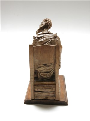Lot 189 - A Black Forest carved wood figure of a seated...