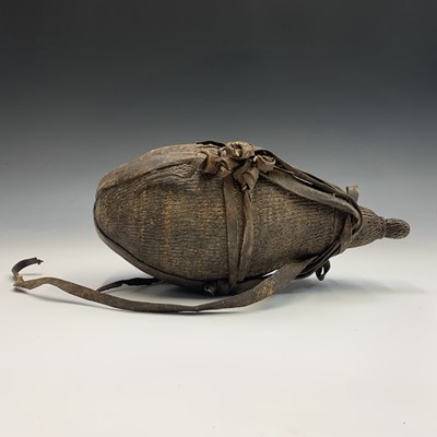 Lot 353 - A tribal water carrier and cover of gourd...