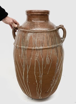 Lot 2004 - A large terracotta olive jar with twin handles....