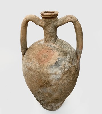 Lot 401 - A terracotta twin handled vessel with incised...