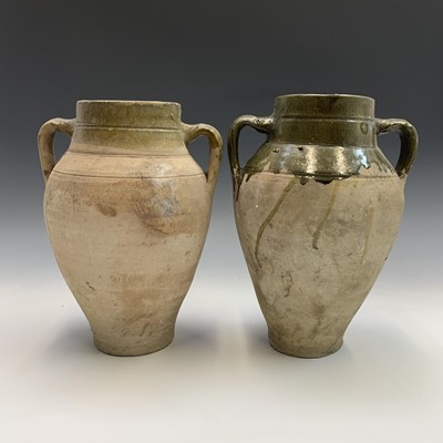 Lot 384 - A near pair of terracotta olive jars with...