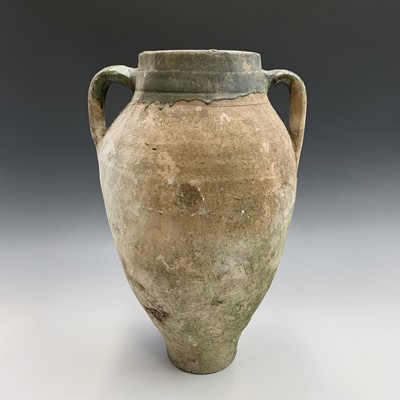 Lot 385 - A terracotta olive jar with green glazed rim....