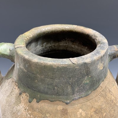Lot 385 - A terracotta olive jar with green glazed rim....