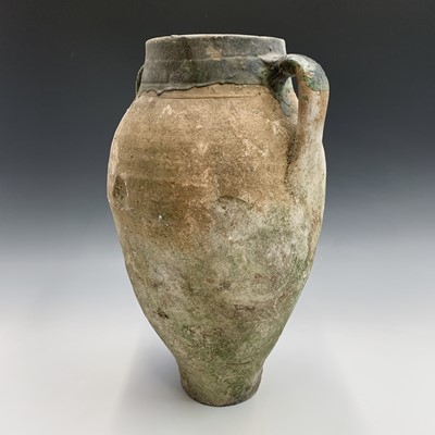Lot 385 - A terracotta olive jar with green glazed rim....