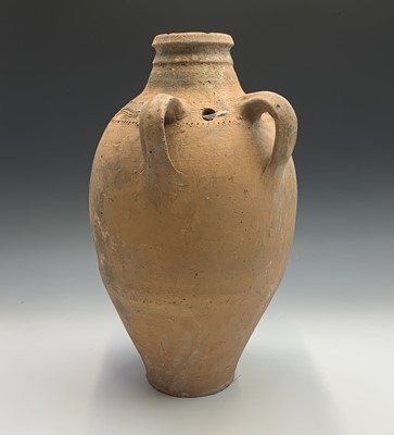 Lot 386 - A terracotta vessel with twin handles, incised...