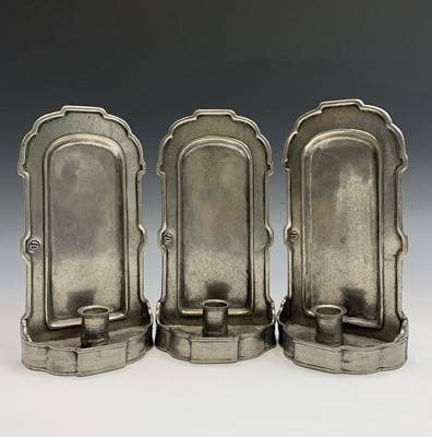 Lot 598 - Three pewter candle wall sconces, height 27cm,...