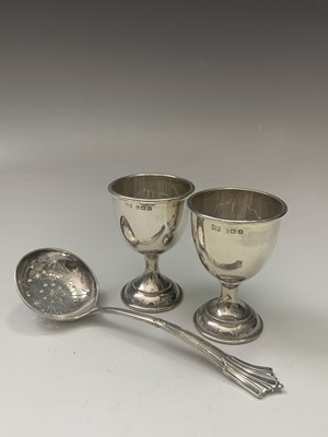 Lot 121 - A pair of plain silver egg cups, a late...