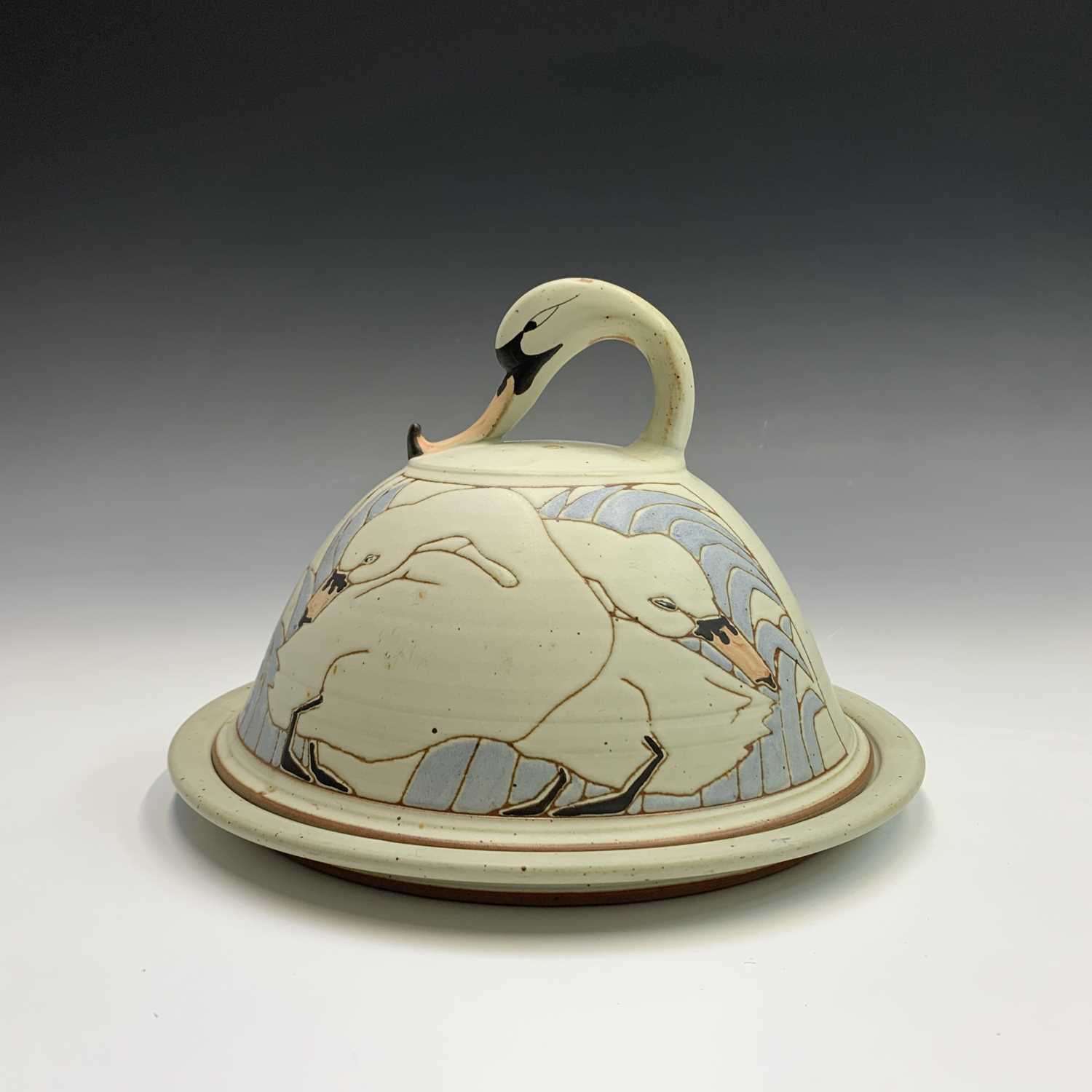 Lot 1056 - An art pottery cheese dome, with incised swan...