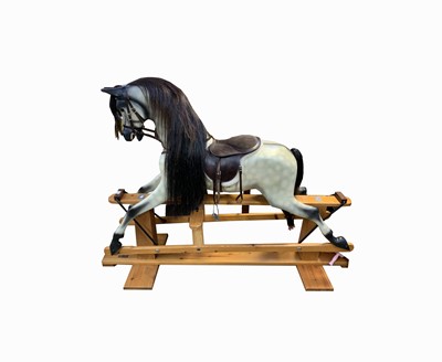 Lot 270 - A rocking horse on a pine stand, dapple grey,...