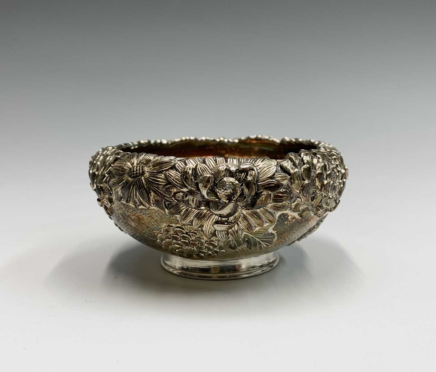 Lot 21 - A Chinese silver chrysanthemum decorated bowl,...