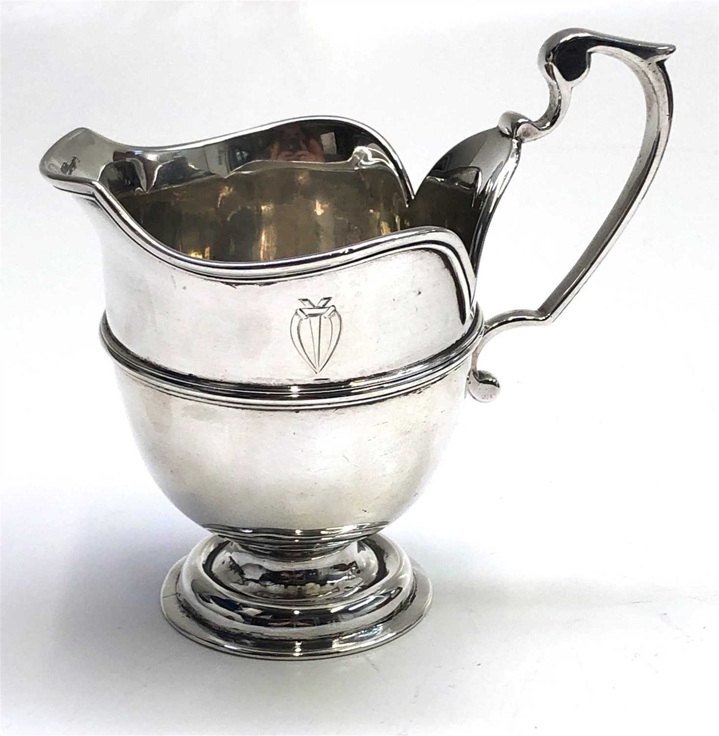 Lot 2049 - A footed silver milk jug with reeded band and...