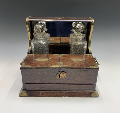 Lot 272 - An Edwardian oak and brass mounted tantalus,...