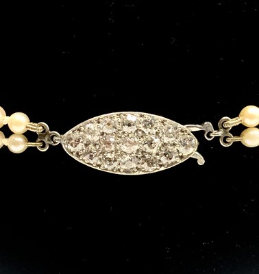 Lot 562 - A double-strand graduated pearl necklace with...