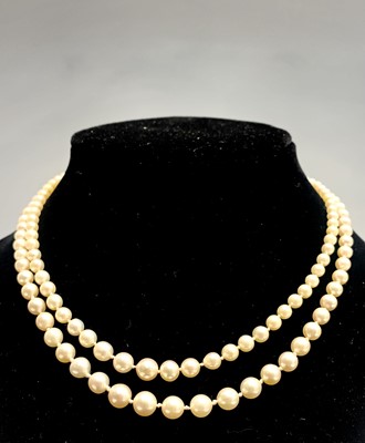 Lot 562 - A double-strand graduated pearl necklace with...