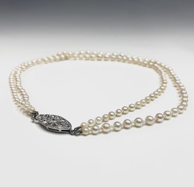 Lot 562 - A double-strand graduated pearl necklace with...