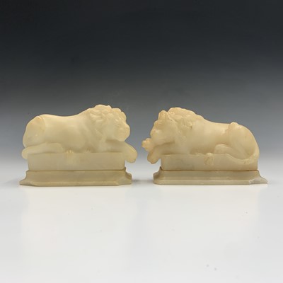 Lot 642 - A pair of carved alabaster recumbent lion...