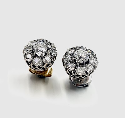 Lot 414 - A pair of diamond cluster earrings by...